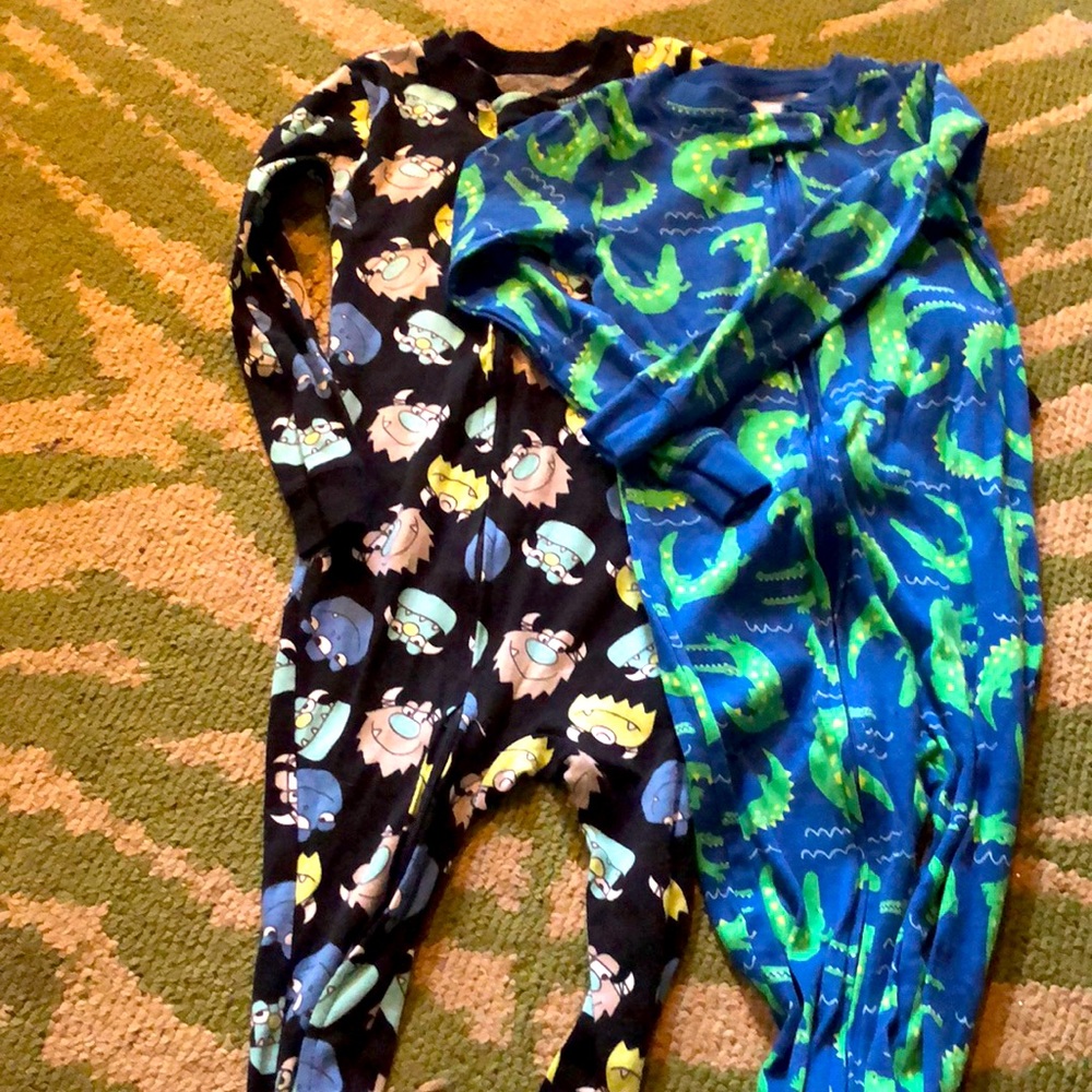 Two pairs of carters zip up footed pajamas